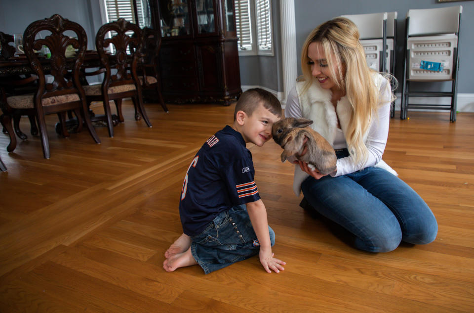Daniel Rafati, 5, and his mother, Lisa Wilkie, play with their pet rabbit Baby Bun Bun at home in Frankfort on Jan. 28, 2019. (Zbigniew Bzdak/Chicago Tribune/Tribune News Service via Getty Images)