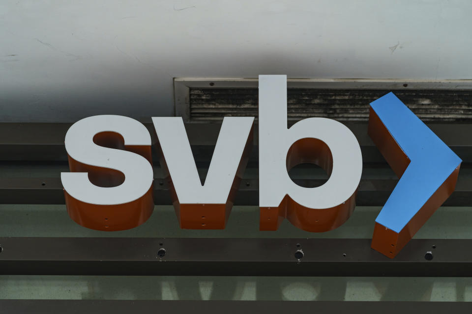 FILE - The Silicon Valley Bank logo is seen at an open branch in Pasadena, Calif., on March 13, 2023. The bidding process for the successor of Silicon Valley Bank is being extended by the Federal Deposit Insurance Corp. to give more time to work out a potential deal. The FDIC said Monday, March 20, 2023 that there’s been “substantial interest” from multiple parties for Silicon Valley Bridge Bank. (AP Photo/Damian Dovarganes, file)