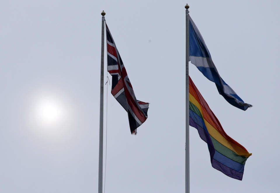 The rainbow flag, bottom right, a symbol of the lesbian, gay, bisexual, and transgender community, flies alongside the British, left, and the Scottish flag over the British government's Scotland Office building, in central London, Friday, March 28, 2014, to mark the start of same-sex weddings in the UK from Saturday March 29, 2014. The British government has ordered rainbow flags to be flown over two prominent government buildings to mark the country’s first same-sex weddings, ahead of the law taking effect on Saturday. It marks a profound shift in attitudes in a country that little more than a decade ago had a law on the books banning the "promotion" of homosexuality. (AP Photo/Lefteris Pitarakis)