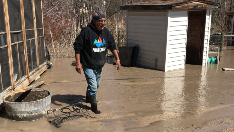 Hot weather heightens B.C. flood risk, families trapped by high water