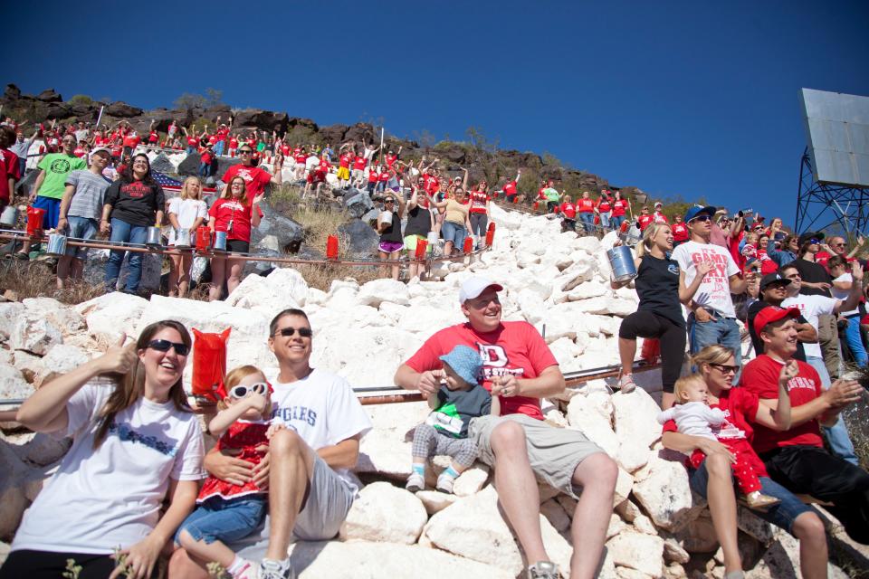 Dixie State students, faculty and members of the community whitewash the "D" in commemoration of the 100th anniversary of the original painting April 18, 2015.