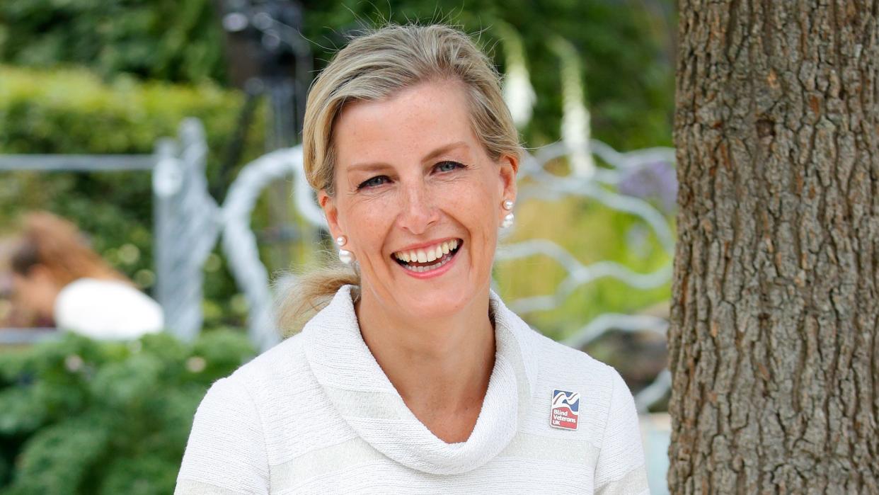 The Duchess of Edinburgh wearing a white dress and smiling at Hampton Court Flower Show