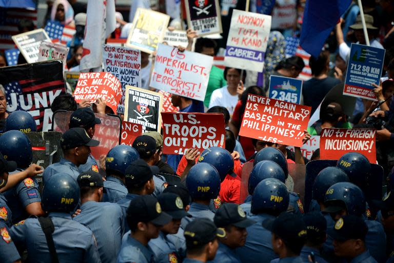 Activists protest in front of the US embassy in Manila on April 23, 2014 against any plans to re-introduce US military bases into the Philippines