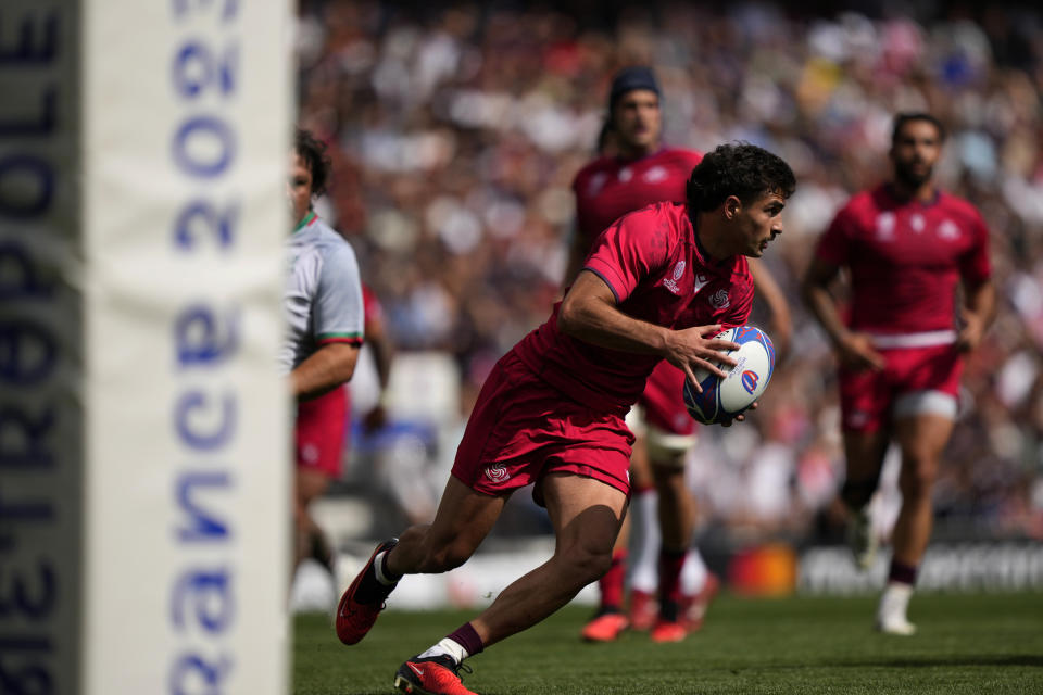 Georgia's Davit Niniashvili runs with the ball during the Rugby World Cup Pool C match between Georgia and Portugal at the Stadium de Toulouse in Toulouse, France, Saturday, Sept. 23, 2023. (AP Photo/Lewis Joly)