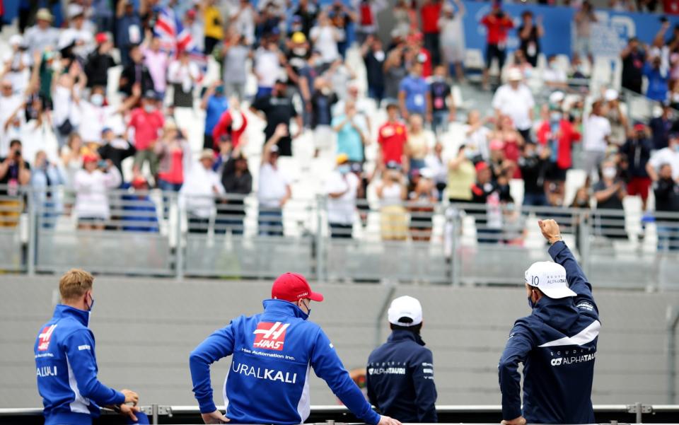 Pierre Gasly of France and Scuderia AlphaTauri (right) waves to the crowd from the back of a truck with Mick Schumacher of Germany and Haas F1, Nikita Mazepin of Russia and Haas F1 and Yuki Tsunoda of Japan and Scuderia AlphaTauri to show their appreciation to the fans prior to the F1 Grand Prix of France at Circuit Paul Ricard on June 20, 2021 in Le Castellet, France - Peter Fox/Getty Images