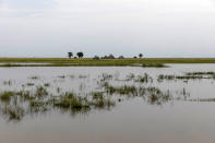 Tukuls - local huts made of mud and grass - are surrounded by water near Malualkon, in Northern Bahr el Ghazal State, South Sudan, Wednesday, Oct. 20, 2021. United Nations says the flooding has affected almost a half-million people across South Sudan since May. (AP Photo/Adrienne Surprenant)