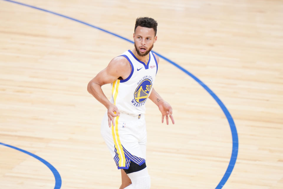 Golden State Warriors' Stephen Curry reacts after making a three-pointer during the first half of an NBA basketball game against the Philadelphia 76ers, Monday, April 19, 2021, in Philadelphia. (AP Photo/Matt Slocum)