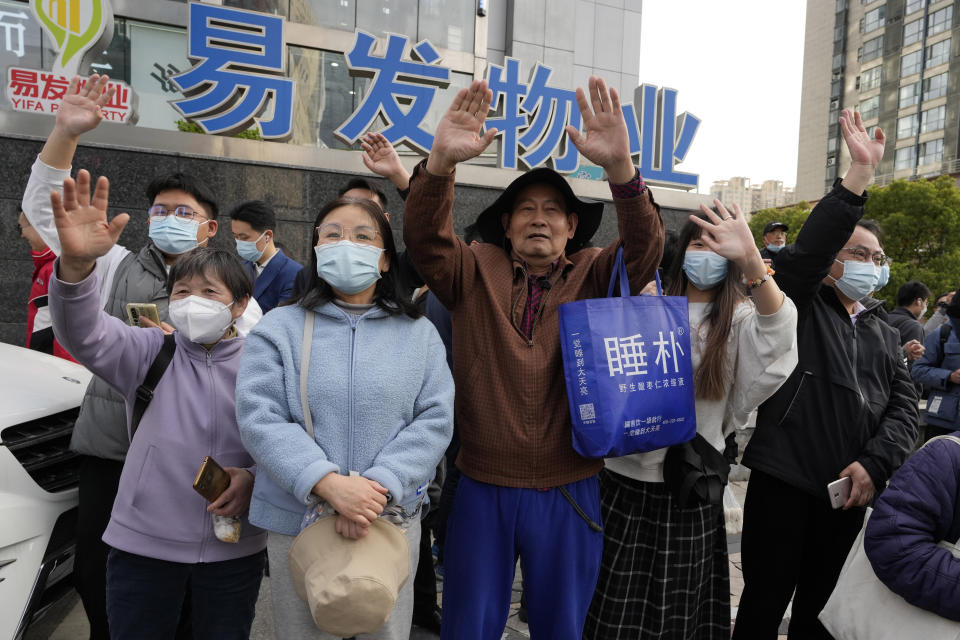 Residents wave as former Taiwan President Ma Ying-jeou leaves from the John Rabe Former Residence during his visit in Nanjing, in eastern China's Jiangsu province, Tuesday, March 28, 2023. Former Taiwan President Ma Ying-jeou began a 12-day tour of China with a symbolism-laden visit to the mausoleum where the founding father of both China and Taiwan is entombed. (AP Photo/Ng Han Guan)