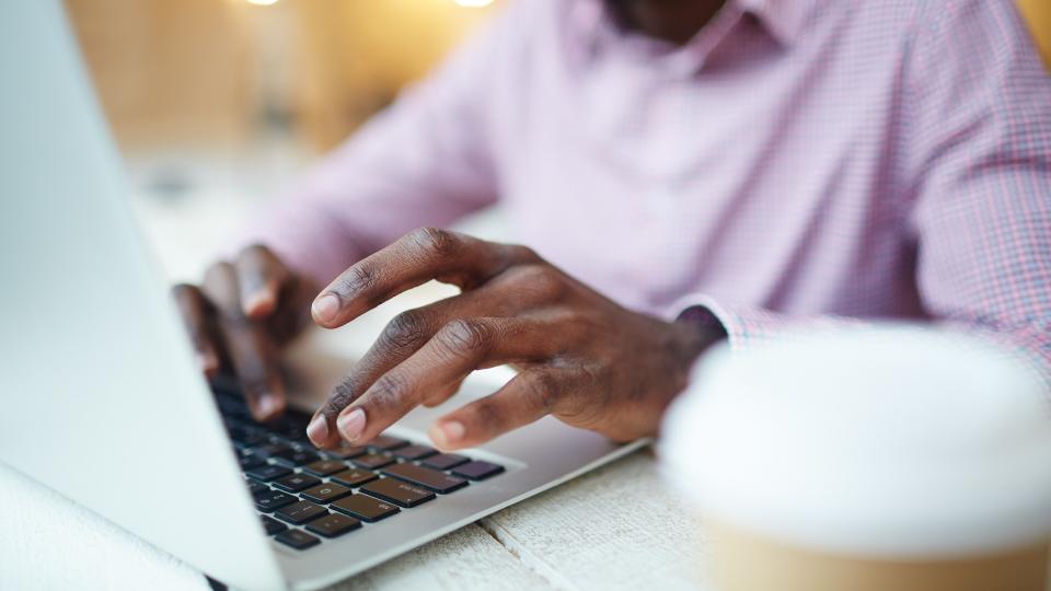 Hands of businessman or designer typing on l aptop.