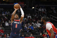 Washington Wizards forward Rui Hachimura (8), of Japan, shoots next to Philadelphia 76ers center Andre Drummond (1) during the first half of an NBA basketball game, Monday, Jan. 17, 2022, in Washington. (AP Photo/Nick Wass)