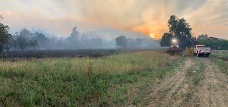 Smoke from the Sand Fire is seen at sunset in the Capay Valley in California