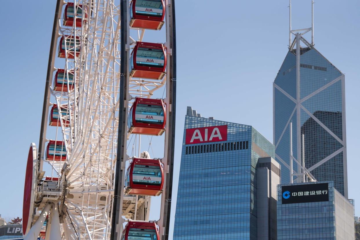 The AIA Central building, which houses the headquarters of AIA Group Ltd., center, next to the Bank of China Tower, rear right, and CCB Tower, in Hong Kong, China, on Wednesday, March 9, 2022. AIA is scheduled to release earnings results on March 11. Photographer: Bertha Wang/Bloomberg
