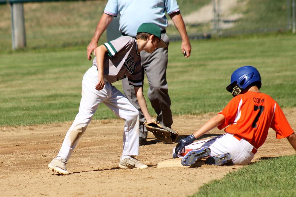 Dover shortstop Slayter Saucier, left, is a little late with the tag as Concord's Hagan Cook is safe at second base during Saturday's Cal Ripken 11-year-old, 60-foot championship game in Dover