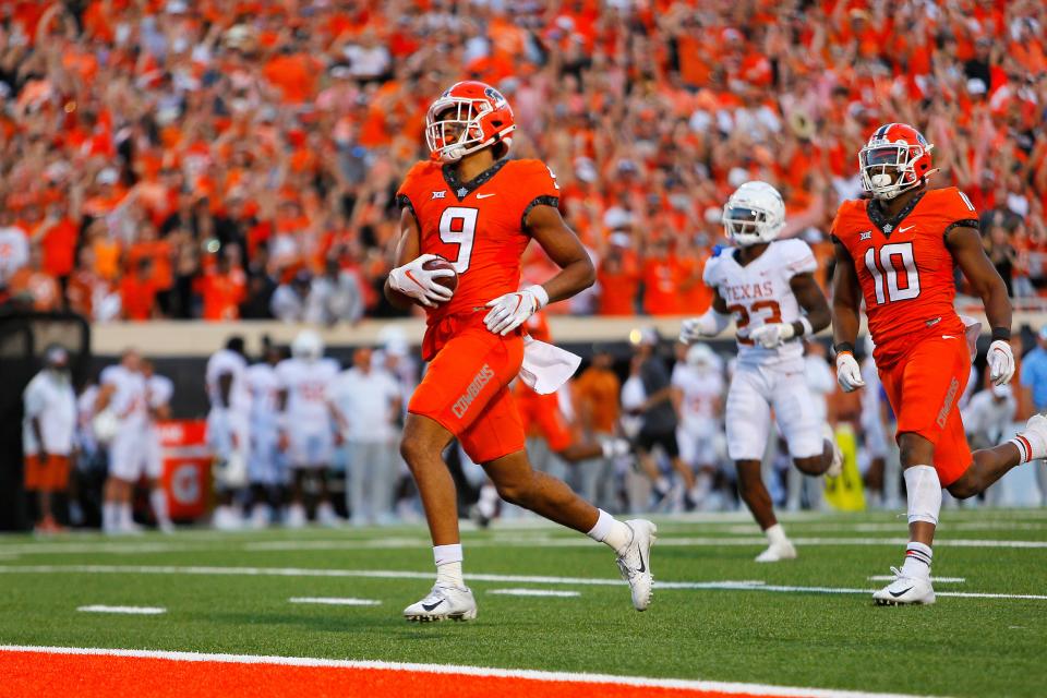 Bryson Green scores the winning touchdown for Oklahoma State after breaking several tackles for a 41-yard reception against the Texas Longhorns with just over a few minutes left in the game at Boone Pickens Stadium on October 22, 2022 in Stillwater, Oklahoma. Oklahoma State won 41-34.