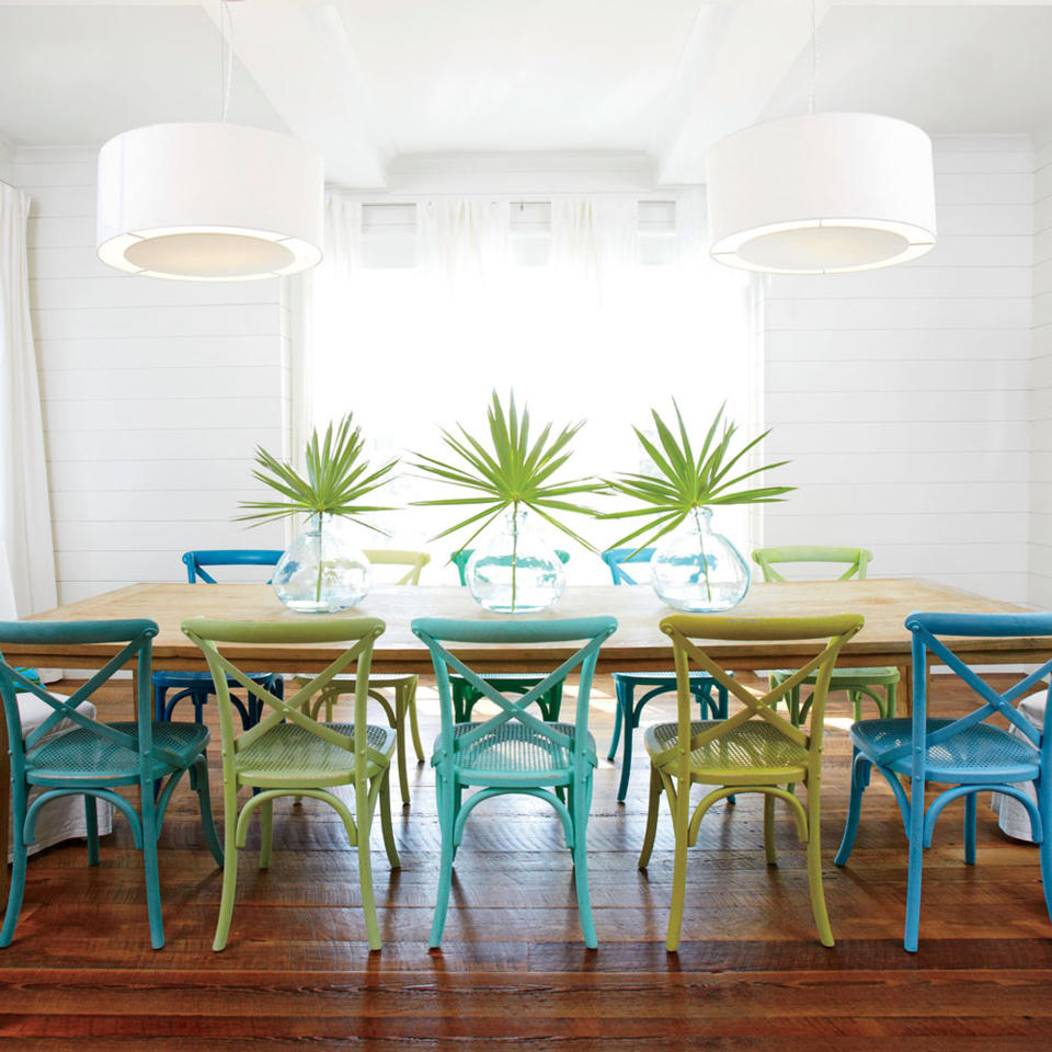 <p>Creamy shiplap walls, mod white pendant lights, and ivory draperies channel bright seaside light, while reclaimed wood floors and a long wooden dining table give the crisp, just-built space a well-worn, well-loved feel.</p> <p><strong>Idea Spotlight</strong></p> <p>Customize furniture to make it your own. Homeowners Erika Klein and Andrea Alexander spray-painted wooden side chairs from Restoration Hardware in varying shades of blue and green for a cheerful, ultra-casual vibe in their Watersound, Florida dining room. </p>