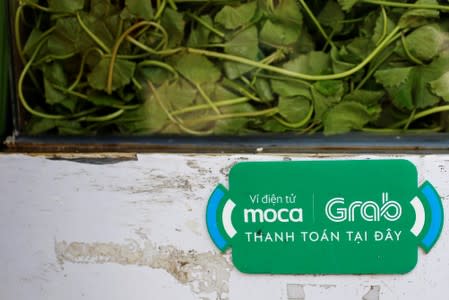 A mobile e-payment logo from Grab is seen at a street food stall in Ho Chi Minh city in Vietnam