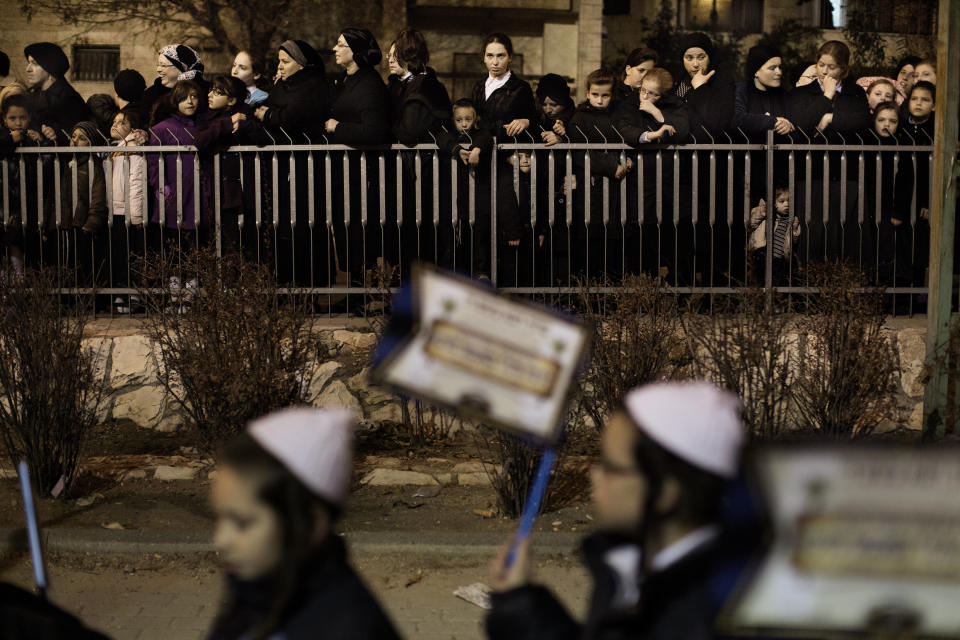 Woman looks on as Ultra Orthodox Jews belonging to the Satmar Hasidic group headed by Satmar Rebbe of Williamsburg, Rabbi Zalman Leib Teitelbaum, gather in the conservative Mea Shearim neighbourhood of Jerusalem on January 20, 2013, two days before nationwide voting for the general election gets underway on January 22. (MARCO LONGARI/AFP/Getty Images)