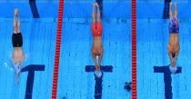 <p>An overview shows Germany's Florian Wellbrock (L), Ukraine's Mykhailo Romanchuk (C) and USA's Robert Finke as they dive to compete in the final of the men's 1500m freestyle swimming event during the Tokyo 2020 Olympic Games at the Tokyo Aquatics Centre in Tokyo on August 1, 2021. (Photo by François-Xavier MARIT / AFP)</p> 