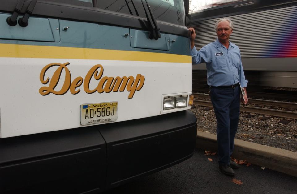 Robert DeCamp, then president of DeCamp Bus Lines, posed in 2003 in the bus company yard next to NJ Transit's railroad lines.