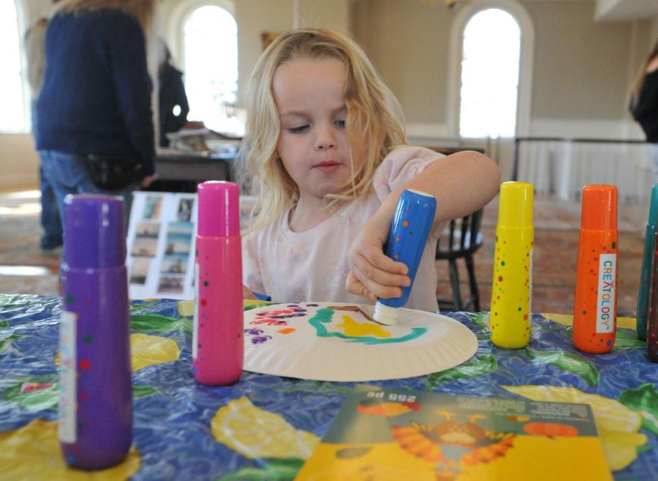 Palmer Brown, 3, of Hingham, decorates her "boat" during the Hingham Historical Society's Colonial Story Time at the society's museum Friday, Nov. 18, 2022.