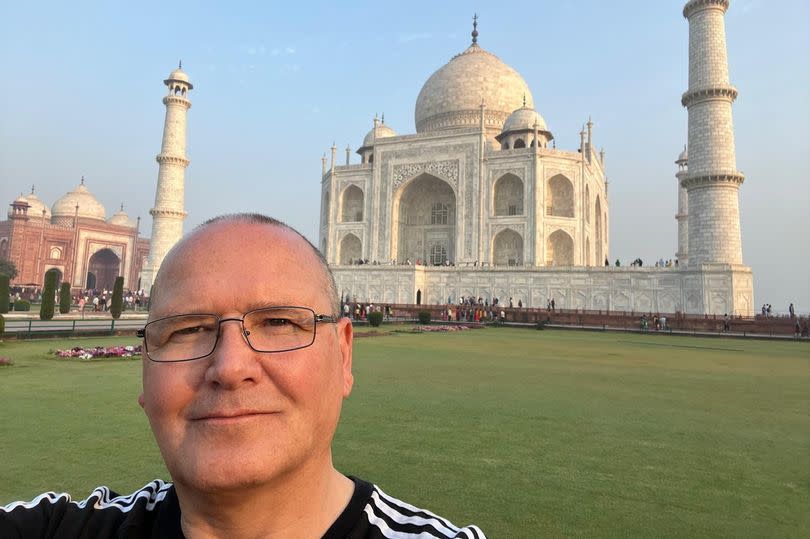 Ian Molland, 55, at the Taj Mahal in India. -Credit:Ian Molland / SWNS