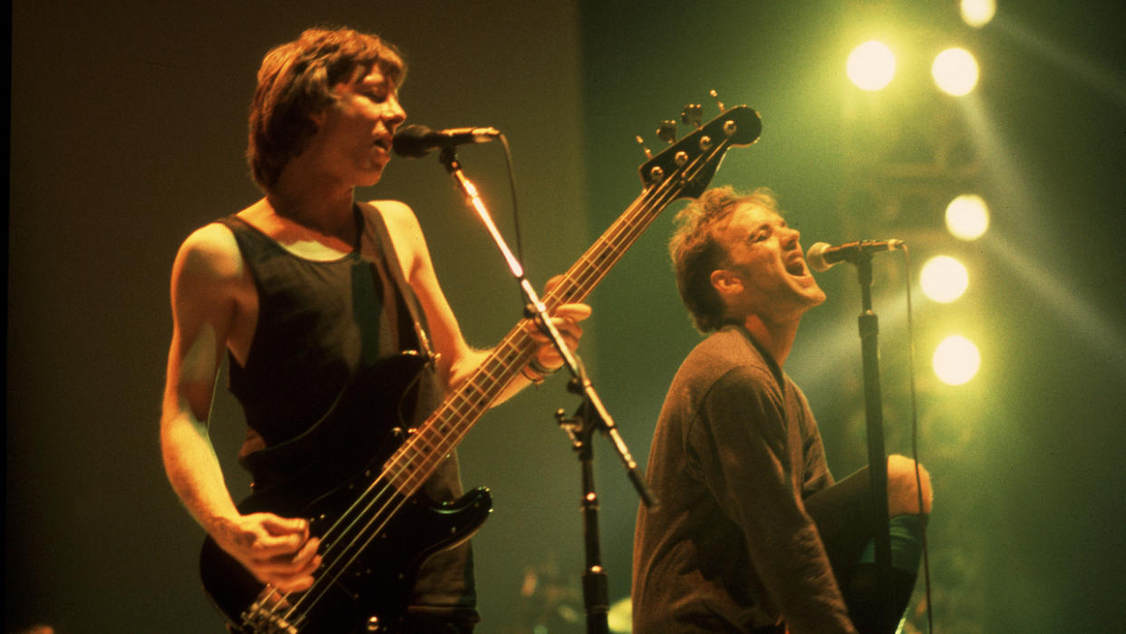  Mike Mills, left, and singer Michael Stipe of REM perform on stage at the Carver Hawkeye Arena in Ames, Iowa, March 10, 1989 