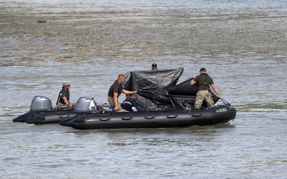 A rescue crew works on the Danube river where a sightseeing boat capsized in Budapest, Hungary, Wednesday, June 5, 2019. Divers and rescue crews slowly are recovering the bodies of a growing number of people killed when a sightseeing boat and a long river cruise ship collided in Hungary's capital. (AP Photo/Laszlo Balogh)