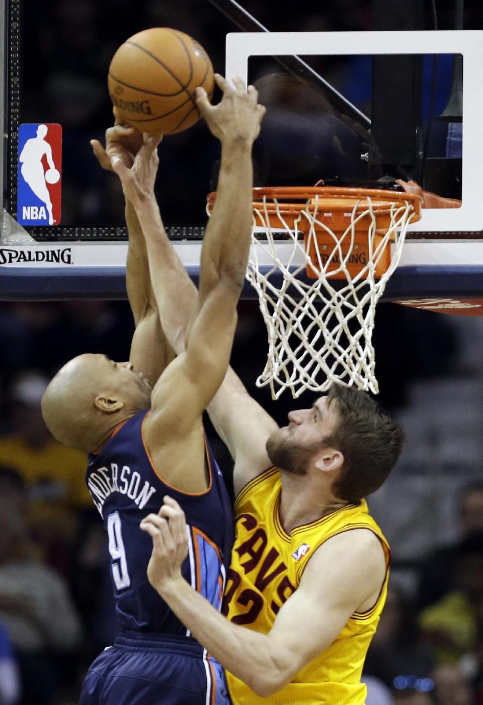 Cleveland Cavaliers' Spencer Hawes, right, fouls Charlotte Bobcats' Gerald Henderson (9) in the second quarter of an NBA basketball game on Saturday, April 5, 2014, in Cleveland. (AP Photo/Mark Duncan)