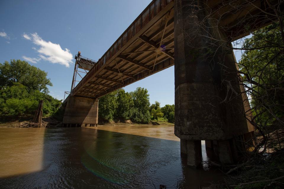 According to the children's book "Eli -- Pride of the Yazoo River," written by Daniel Brown, Eli, a gaint catfish, lives under the Yazoo River bridge in Satartia, Miss., background. Satartia, Mississippi's tiniest town, is holding a festival to celebrate the fictitious giant catfish on July 30, 2022.