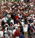 <p>Masters champion Tiger Woods is engulfed by the gallery as he makes his way to the 18th after his second shot during final round play at the Augusta National Golf Club in Augusta, Ga., Sunday, April 13, 1997. (AP Photo/Amy Sancetta ) </p>
