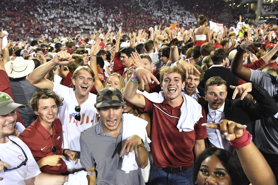 Arkansas fans celebrate the team's win over Texas in an NCAA college football game Saturday, Sept. 11, 2021, in Fayetteville, Ark. (AP Photo/Michael Woods)
