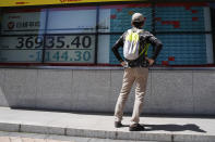 A person looks at an electronic stock board showing Japan's Nikkei 225 index at a securities firm Friday, April 19, 2024, in Tokyo. (AP Photo/Eugene Hoshiko)