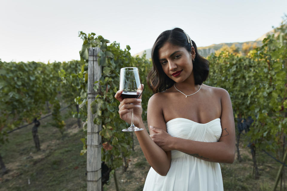 A bride holding a wine glass
