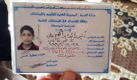 The ID card/childhood photo of teenage Islamic State militant Atheer Ali is seen in Mosul, Iraq, February 4, 2017. Picture taken February 4, 2017. REUTERS/Stephen Kalin