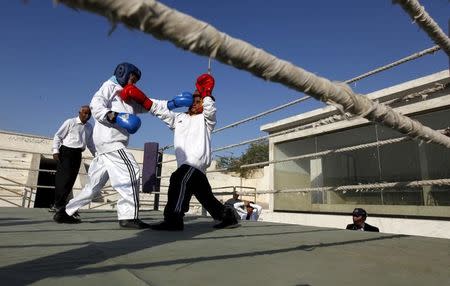 Tabia (L), 12, fights against Aamna, 11, during the Sindh Junior Sports Association Boxing Tournament in Karachi, Pakistan February 21, 2016. REUTERS/Akhtar Soomro