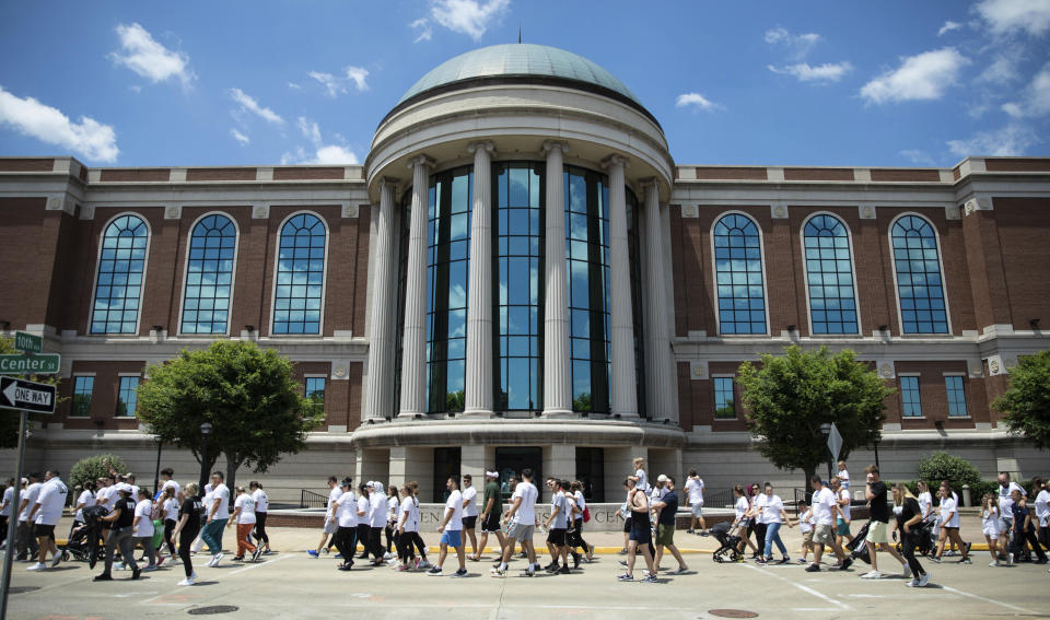 Hundreds of Bowling Green's Bosnian residents, lead by a group of survivors of the Srebrenica massacre, walk by the Warren County Justice Center and throughout downtown Bowling Green, Ky., in a peace march consisting of 8,372 steps, one for each victim, Sunday, July 10, 2022. The walk marks the 27th anniversary of the massacre, which took the lives of 8,372 Bosniaks by Bosnian Serbs in the town of Srebrenica in July 1995 and drove more than 20,000 civilians from the area. (Grace Ramey/Daily News via AP)