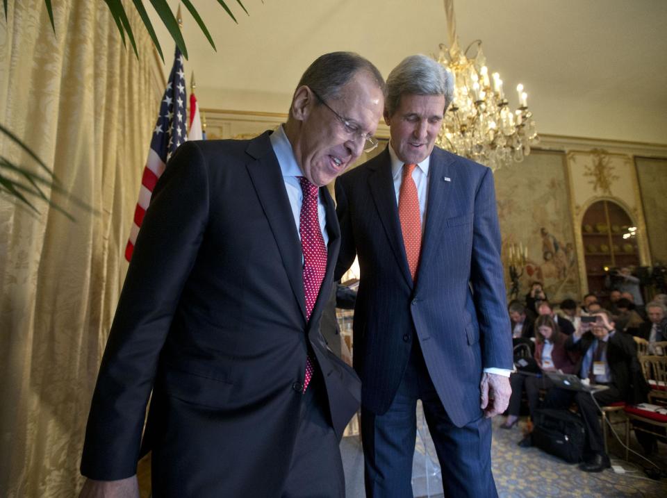 US Secretary of State John Kerry, right, walks with Russia's Foreign Minister Sergey Lavrov, left, following the conclusion of their joint news conference with U.N-Arab League envoy for Syria Lakhdar Brahimi, at the US Ambassador's residence in Paris, France, Monday, Jan. 13, 2014. Kerry is in Paris for meetings on Syria to rally international support for ending the three-year civil war in Syria. (AP Photo/Pablo Martinez Monsivais, Pool)