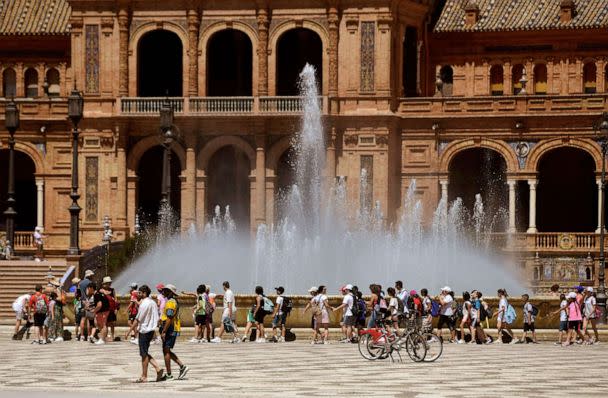 PHOTO: A group of school children cool off walking along a fountain at the Plaza Espana square in Seville on April 26, 2023 as Spain is bracing for an early heat wave. (Cristina Quicler/AFP via Getty Images, FILE)