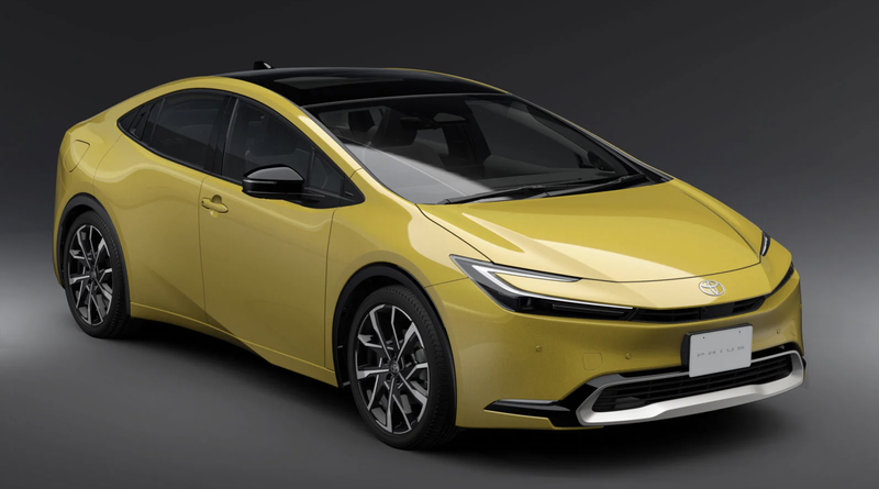 A yellow 2023 Toyota Prius in a studio.