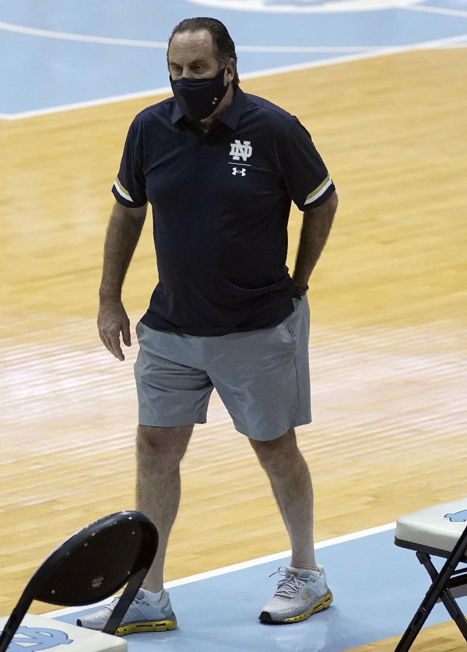 Notre Dame head coach Mike Brey looks on before an NCAA college basketball game against North Carolina in Chapel Hill, N.C., Saturday, Jan. 2, 2021. Brey said he took the notion of acceptable coaching attire to a "ridiculously new level" for the Jan. 2 game at North Carolina. He said wanted to loosen up his players, so he put on the gray shorts under his blue polo. (AP Photo/Gerry Broome)