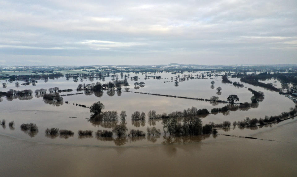 Fields remain flooded after the River Severn broke its banks near Apperley, England, Tuesday Dec. 29, 2020.  In the aftermath of Storm Bella some flood warnings are still in place although cold weather has bought snow and ice to some areas. (Steve Parsons/PA via AP)