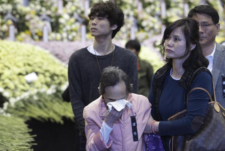 A woman cries as she pays tribute to the victims of the sunken ferry Sewol at a group memorial altar in Ansan, South Korea, Saturday, May 3, 2014. More than 300 people are dead or missing in the disaster that has caused widespread grief, anger and shame. (AP Photo/Ahn Young-joon)