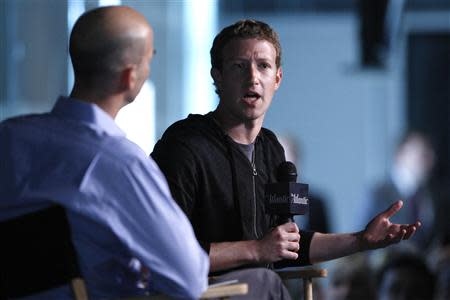 Facebook CEO Mark Zuckerberg (R) speaks during an onstage interview with James Bennet (L) of the Atlantic Magazine in Washington, September 18, 2013. REUTERS/Jonathan Ernst