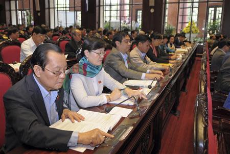 Vietnam's National Assembly's deputies press voting buttons to pass the new constitution during a meeting in Hanoi November 28, 2013. REUTERS/Stringer