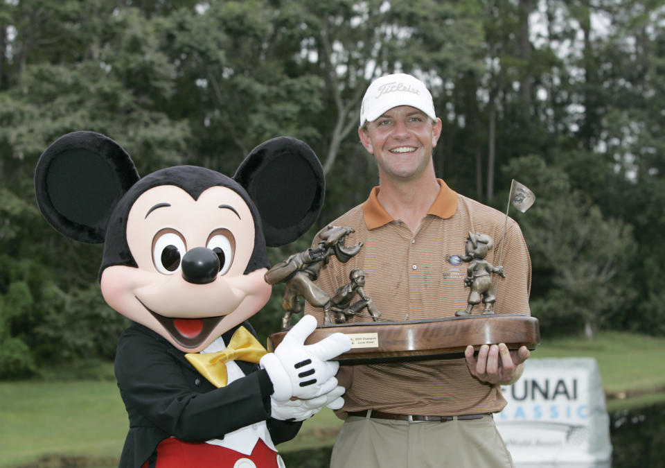 Lucas Glover and Mickey Mouse hold the trophy after Glover won his first PGA Tour title at the 2005 Funai Classic held on the Magnolia course at Walt Disney World Resort in Lake Buena Vista, Florida. (Sam Greenwood/Getty Images)