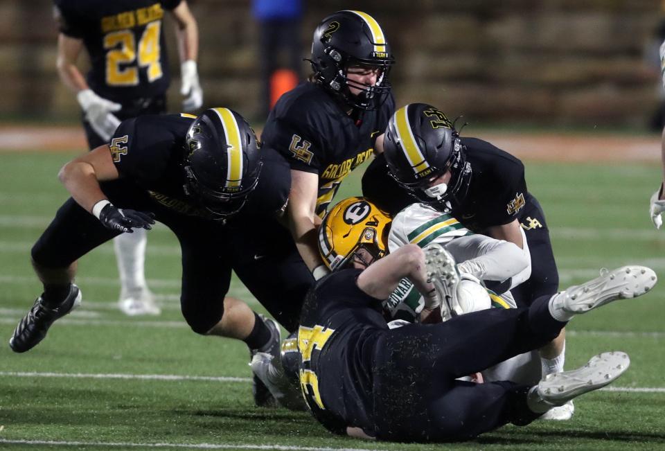 St. Edward's Danny Enovitch is brought down by UA's Chris Reynolds (34), Carter Brock (44), Jack Purcell (2) and Doak Buttermore (4) during the state semifinal.