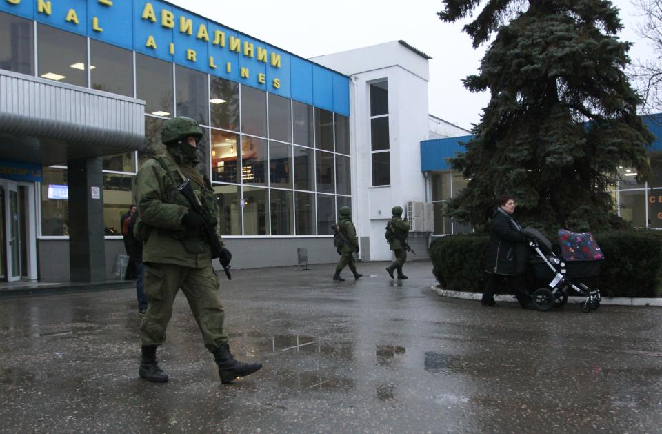 Armed men patrol at the airport in Simferopol