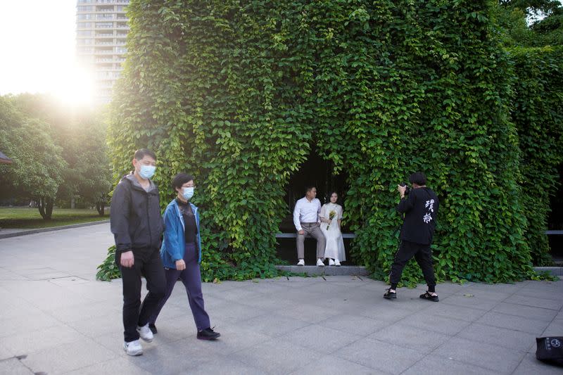 Peng Jing, 24, and Yao Bin, 28, pose for their wedding photography shoot after the lockdown was lifted in Wuhan