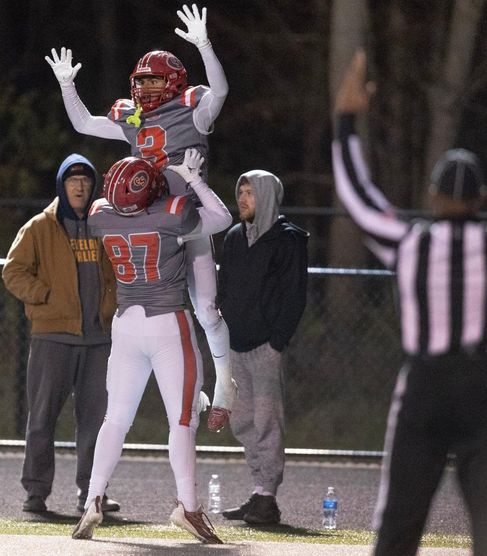 Canton South's Tavon Castle is lifted up by teammate Luke Johnson after a second-half touchdown vs. Buchtel last Friday.