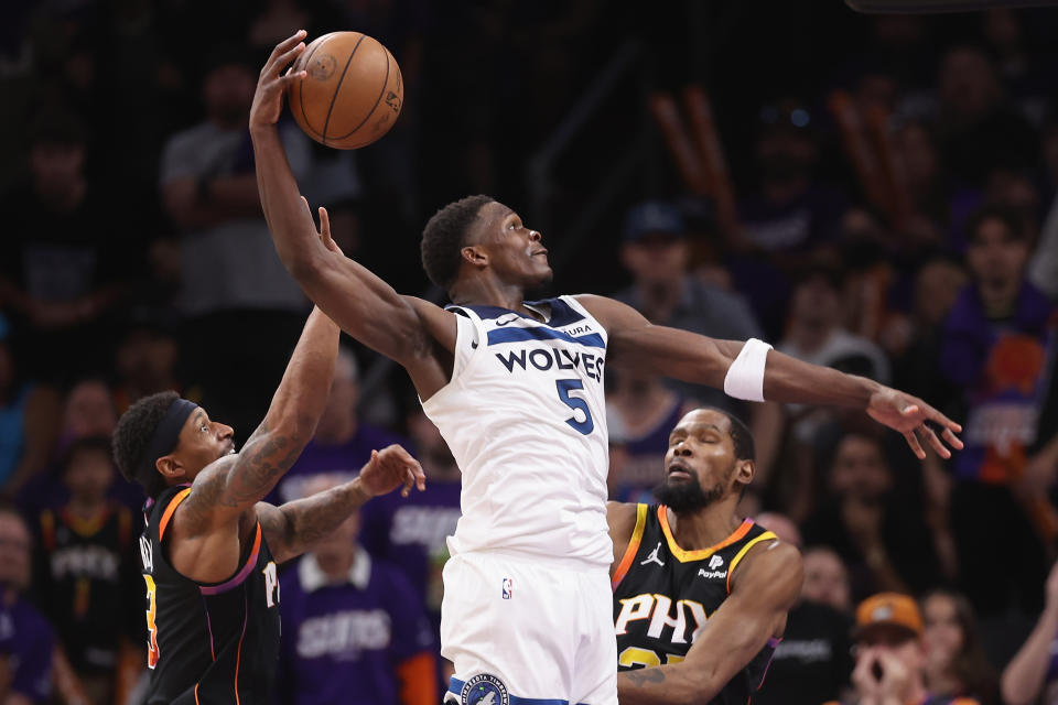 PHOENIX, ARIZONA - APRIL 28: Anthony Edwards #5 of the Minnesota Timberwolves slam dunks the ball ahead of Bradley Beal #3 and Kevin Durant #35 of the Phoenix Suns during the second half of game four of the Western Conference First Round Playoffs at Footprint Center on April 28, 2024 in Phoenix, Arizona. The Timberwolves defeated the Suns 122-116 and win the series 4-0. NOTE TO USER: User expressly acknowledges and agrees that, by downloading and or using this photograph, User is consenting to the terms and conditions of the Getty Images License Agreement.  (Photo by Christian Petersen/Getty Images)